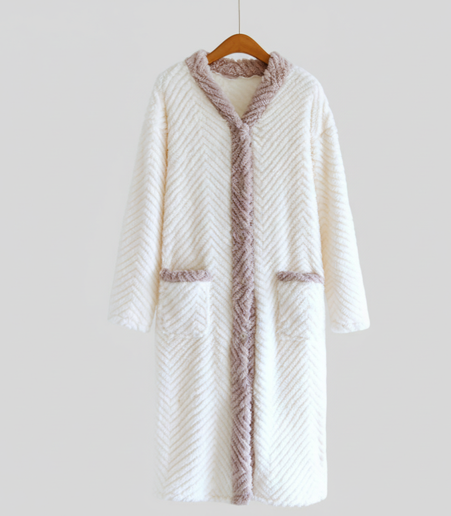 White textured robe with brown trim on a hanger against a white background