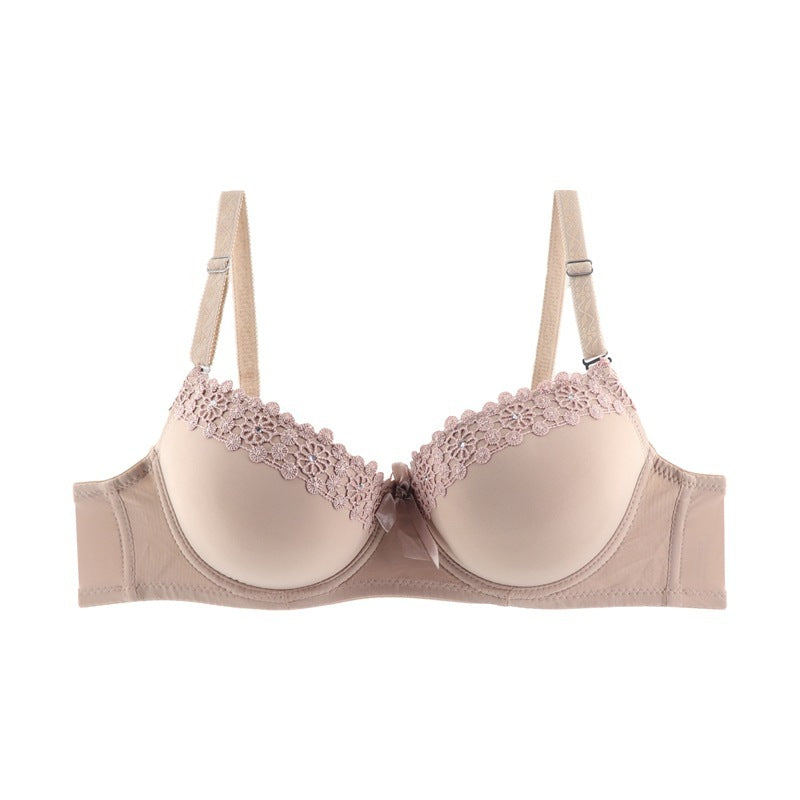 Beige bra with lace detailing on a white background