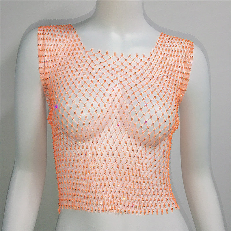 Mannequin wearing a peach-colored fishnet top on a plain background