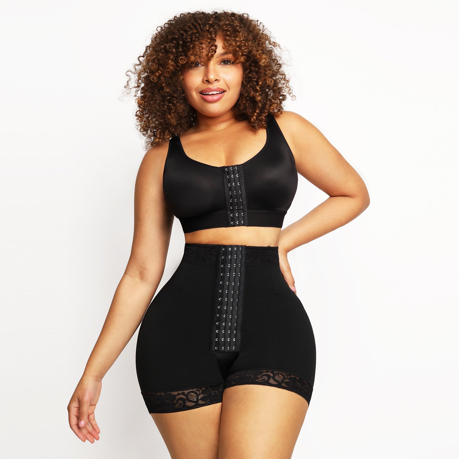 Woman wearing a black shapewear outfit on a white background