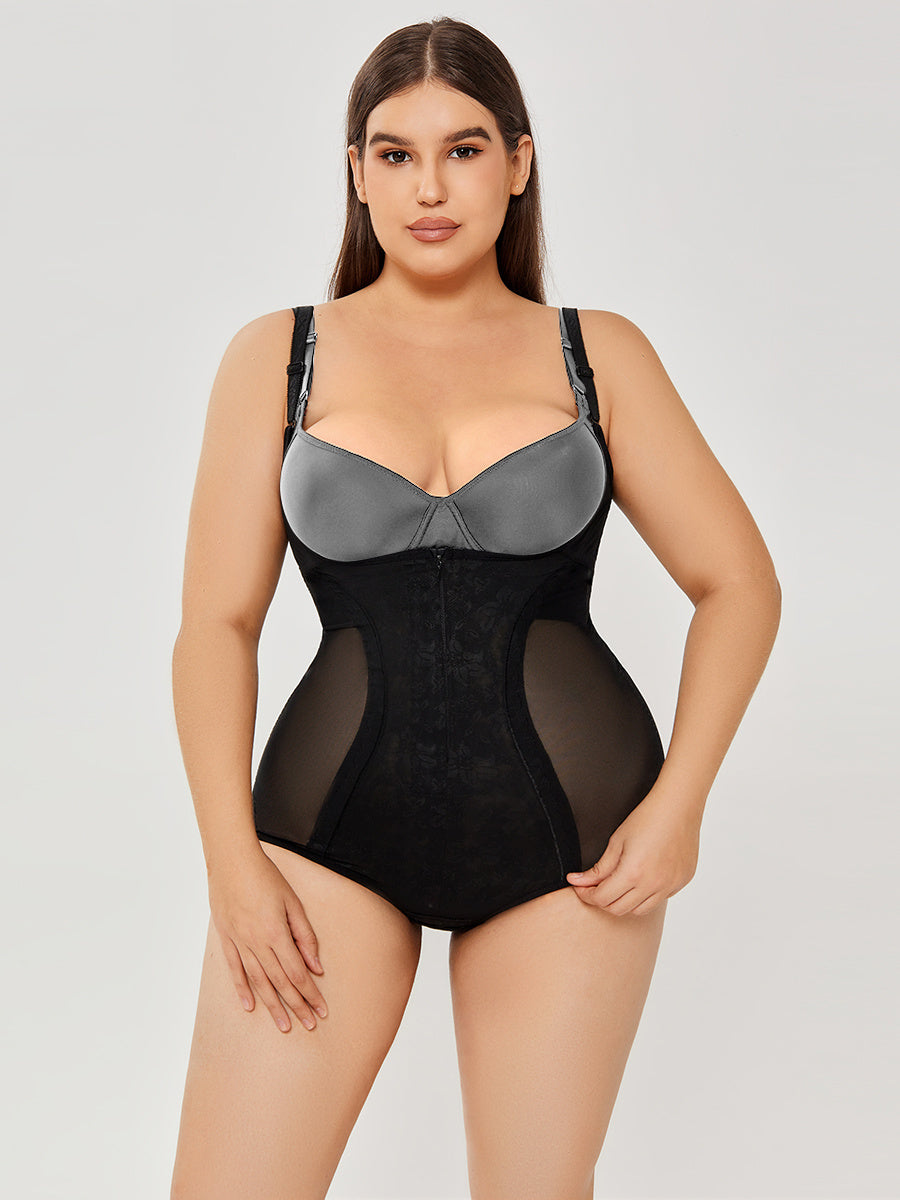 Woman wearing a black bodysuit with sheer panels on a plain background