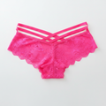 Pink lace lingerie set on a light gray background