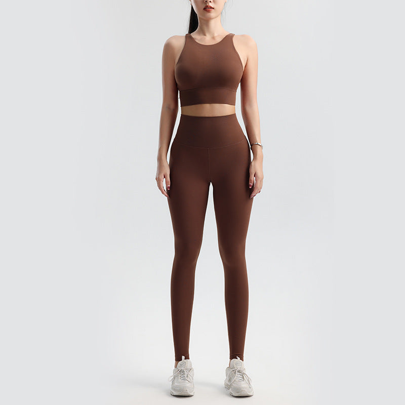 Person wearing a brown athletic outfit on a white background