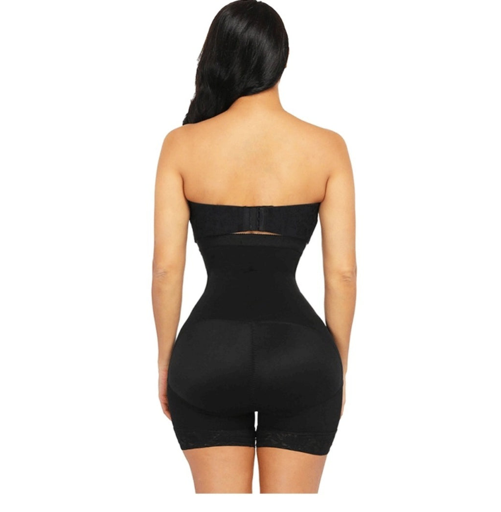 Black strapless bodysuit worn by a model on a white background