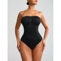 Black strapless bodysuit worn by a model on a light gray background