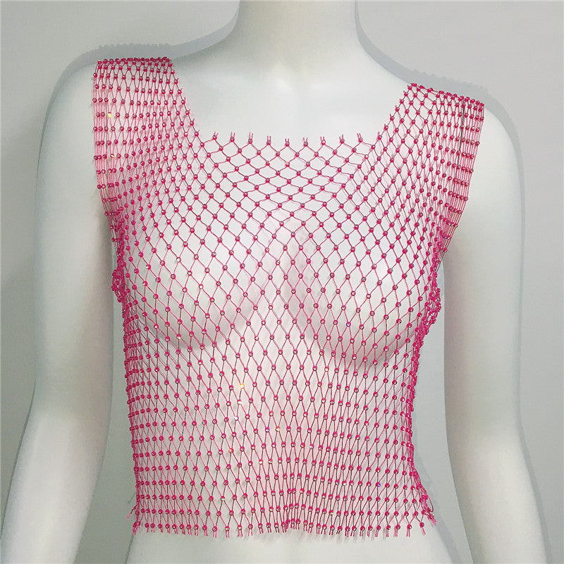 Mannequin wearing a pink fishnet top against a plain background