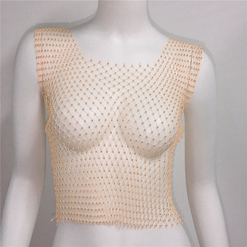 Mannequin wearing a beige mesh top against a plain background