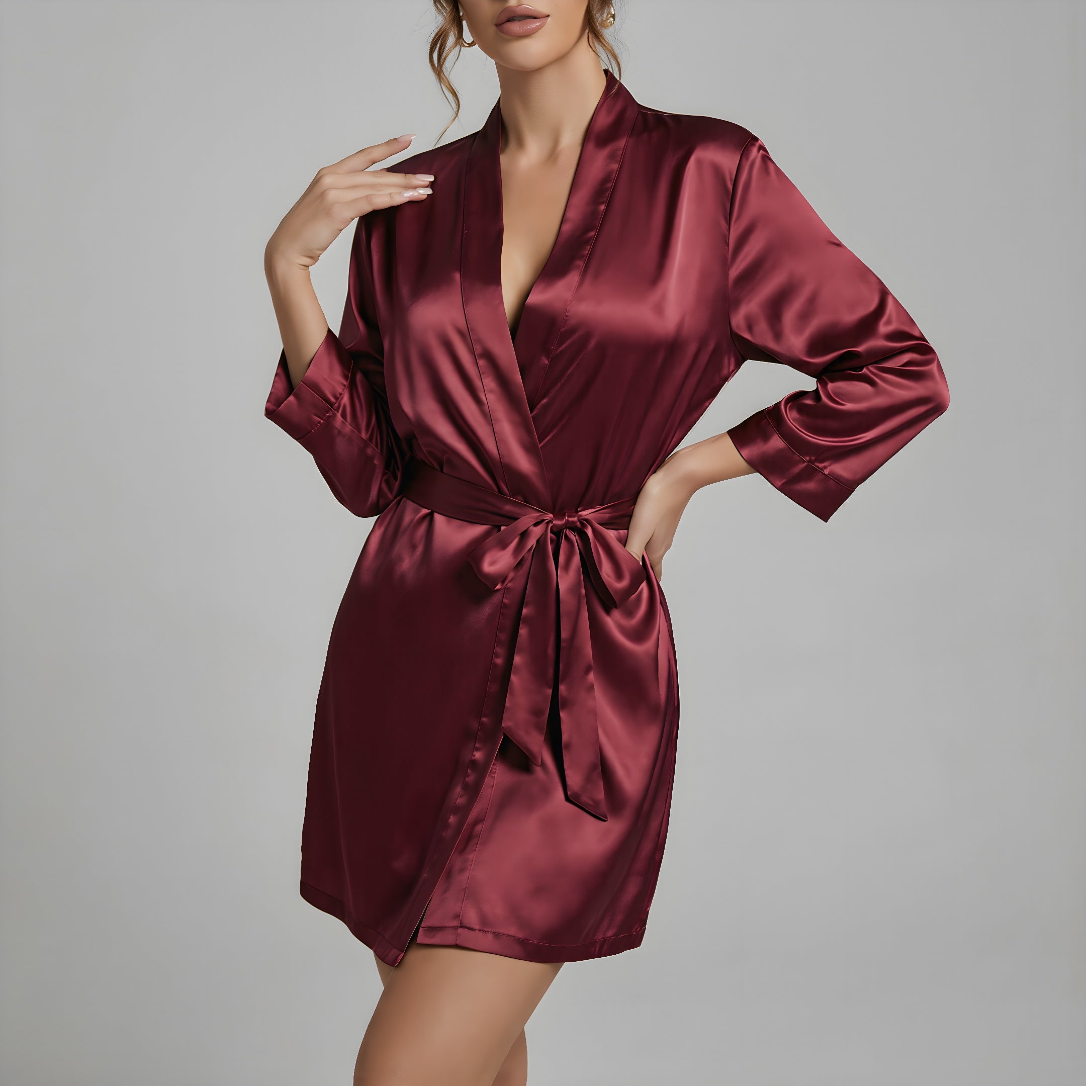 wine red satin robe worn by a model on a gray background