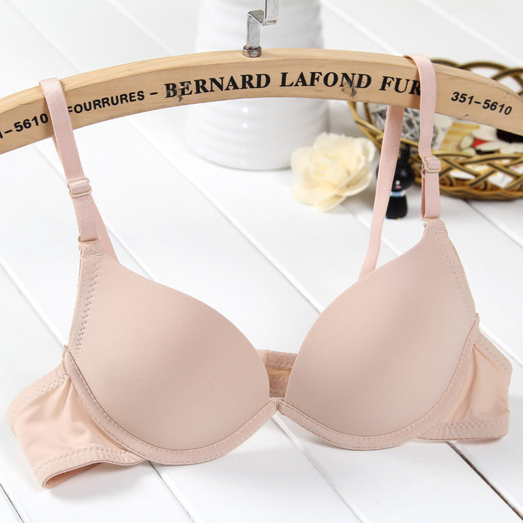 Beige bra on a hanger with 'Bernard Lafond' branding in the background.