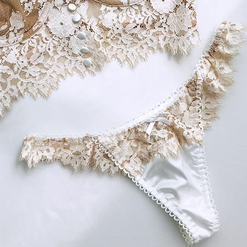 Close-up of beige lace lingerie on a white background