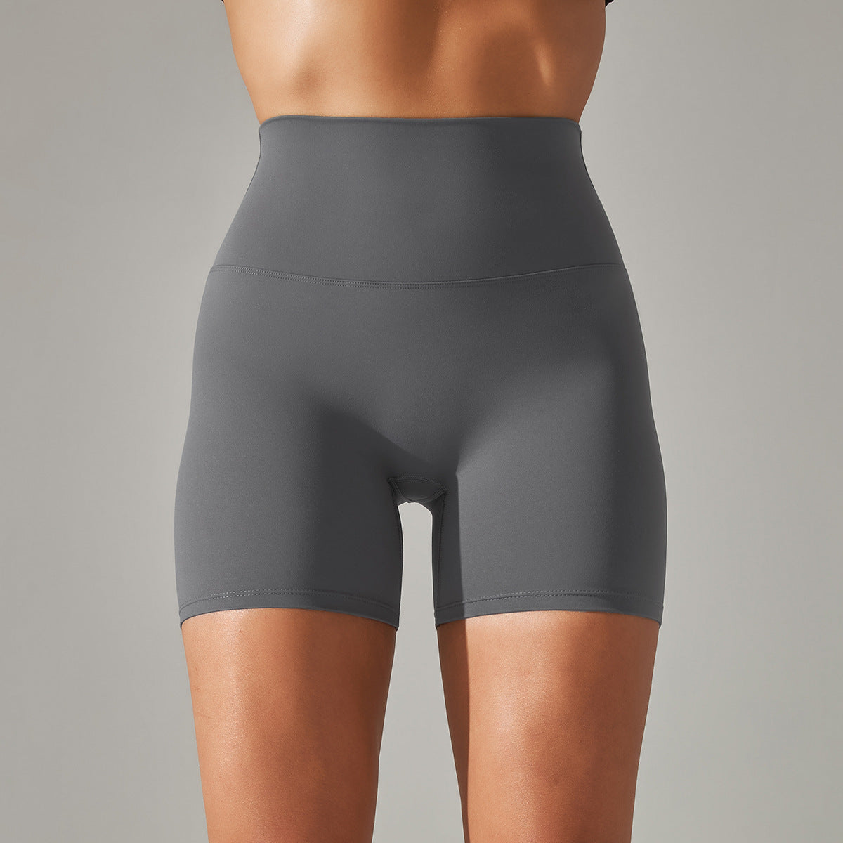 Gray high-waisted shorts worn by a person on a gray background