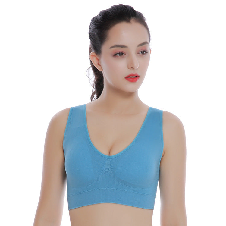 Woman wearing a blue sports bra on a white background