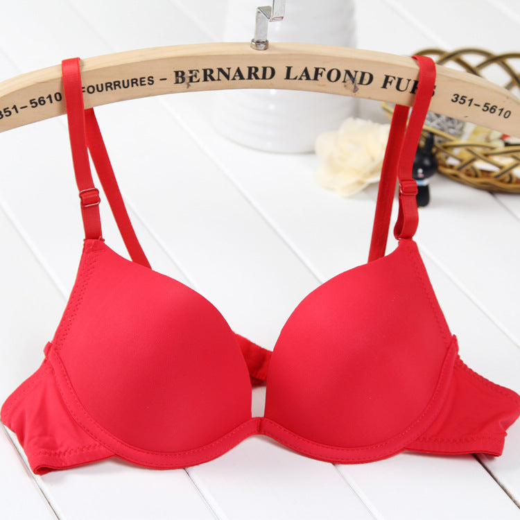 Red bra on a wooden hanger with 'Bernard Lafond' branding.