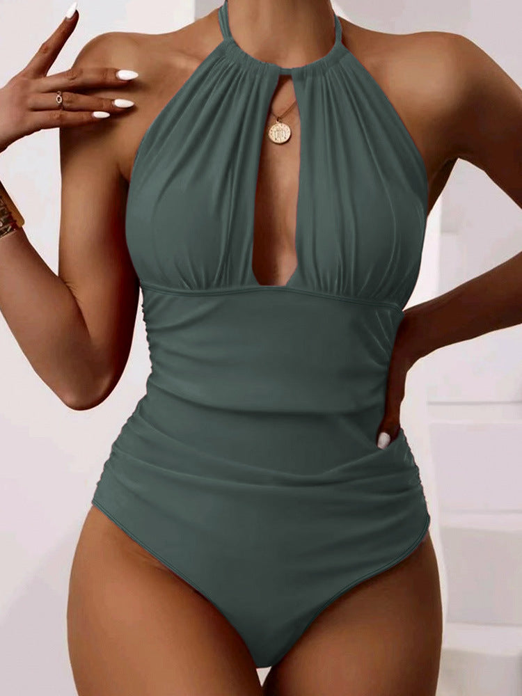 Green halter neck swimsuit worn by a model on a white background
