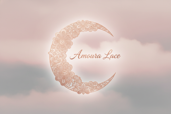 Elegant crescent moon made of lace and floral patterns in rose gold, with the text "Amoura Lace" in the center in graceful script. Soft blush and moonlit gray background, dreamy and feminine logo style.