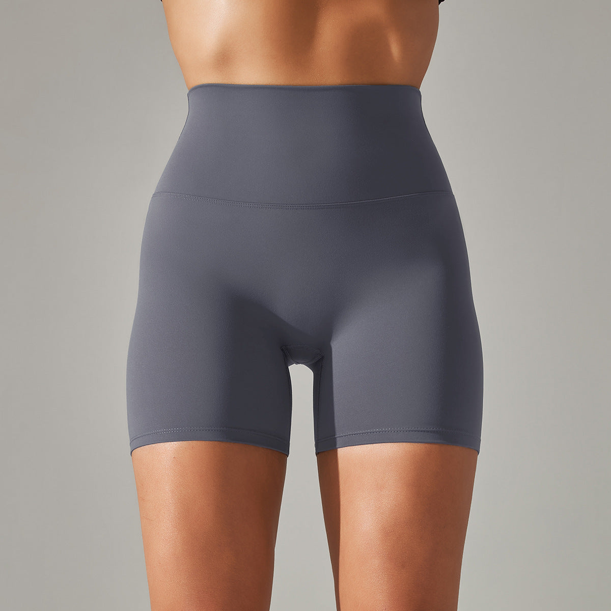 Gray athletic shorts worn by a person on a gray background