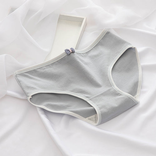 Gray women's underwear on a white fabric background