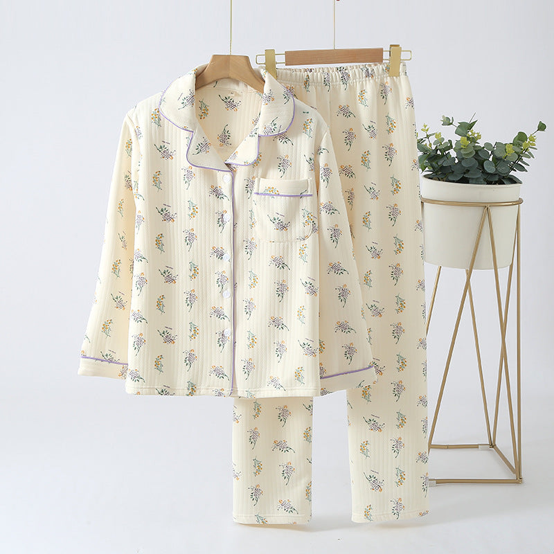 Floral pajama set on a hanger with a plant in the background