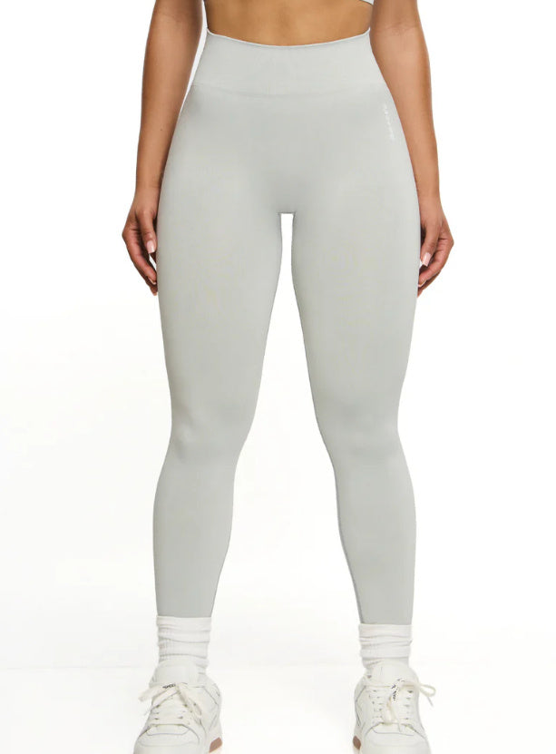 Person wearing light gray leggings on a white background