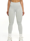 Person wearing light gray leggings on a white background