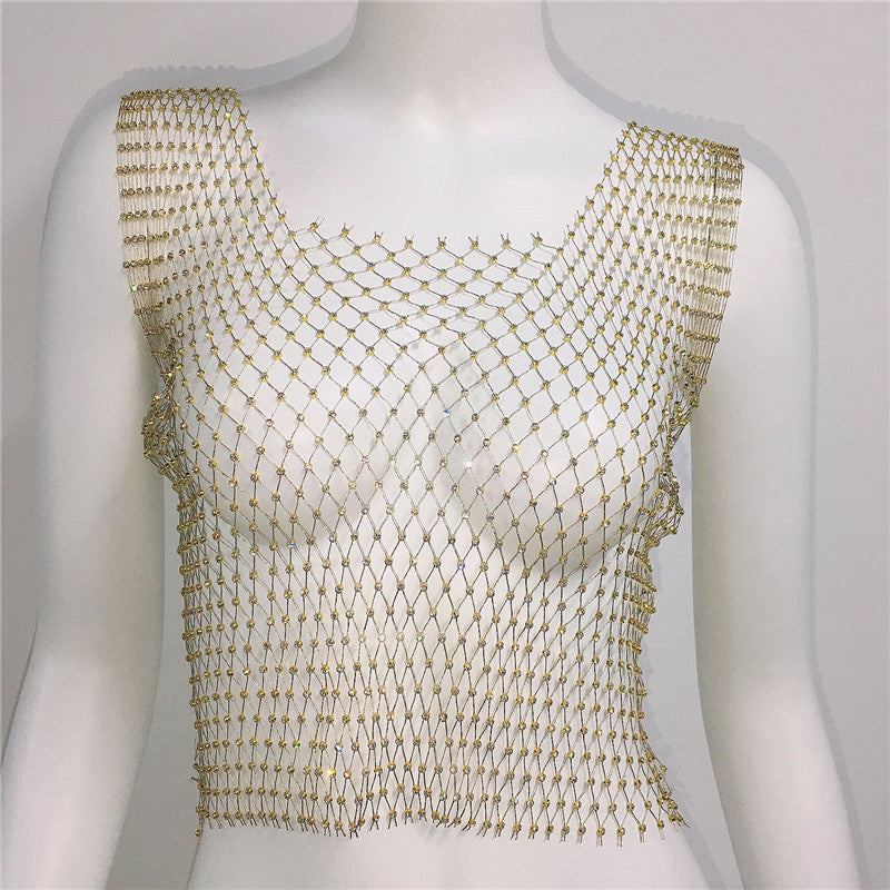 Gold fishnet top on a mannequin against a white background