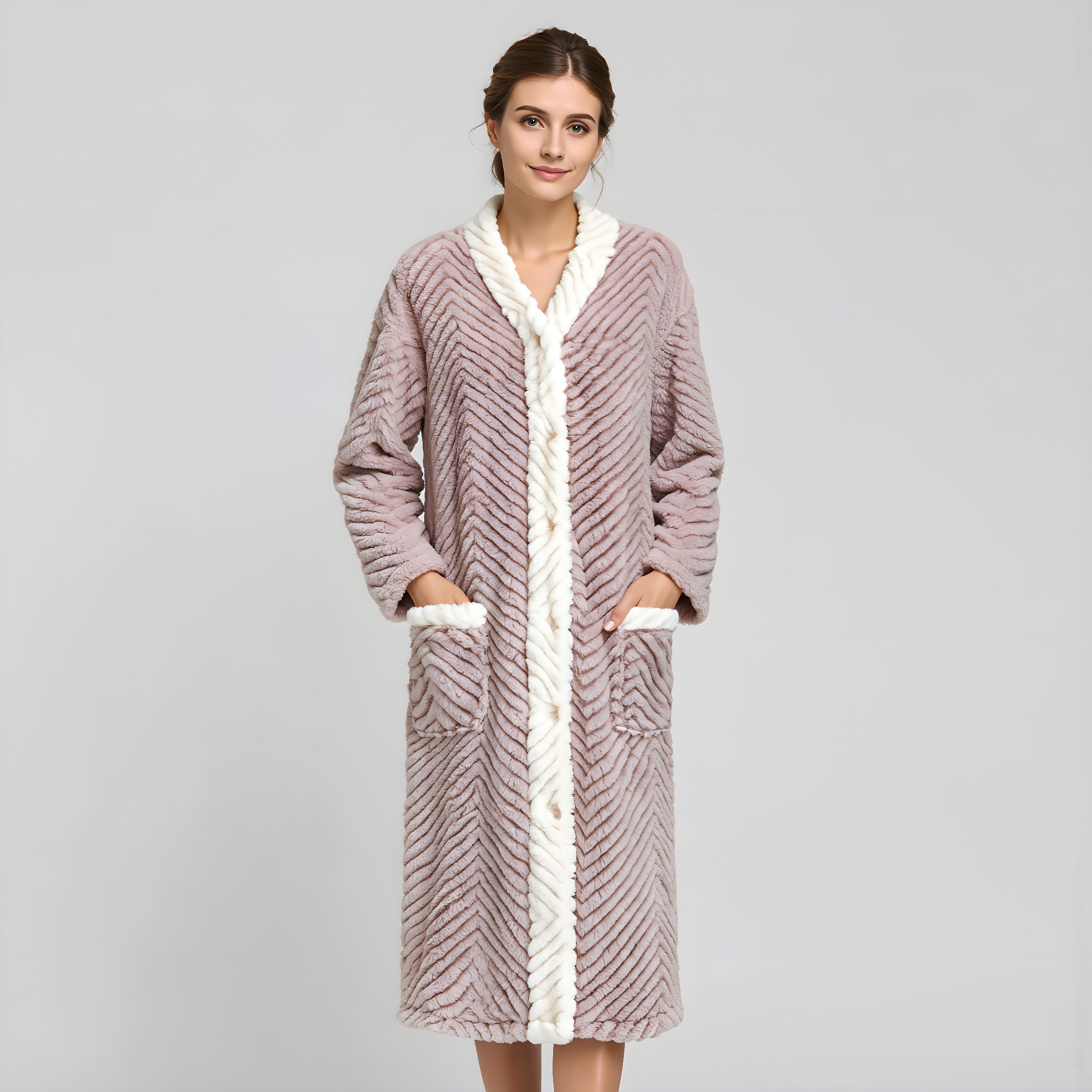 Woman wearing a long, textured robe with white trim on a gray background