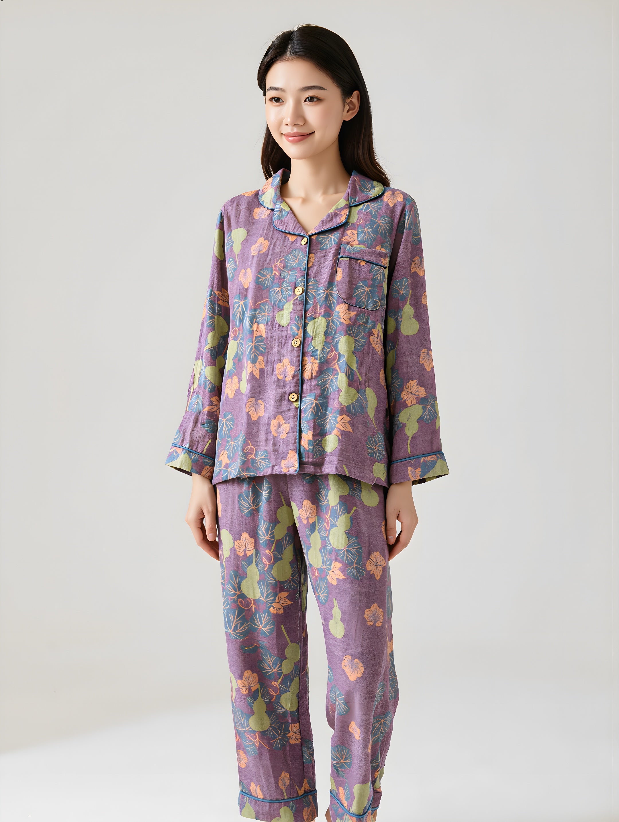 Woman wearing a floral pajama set on a plain background