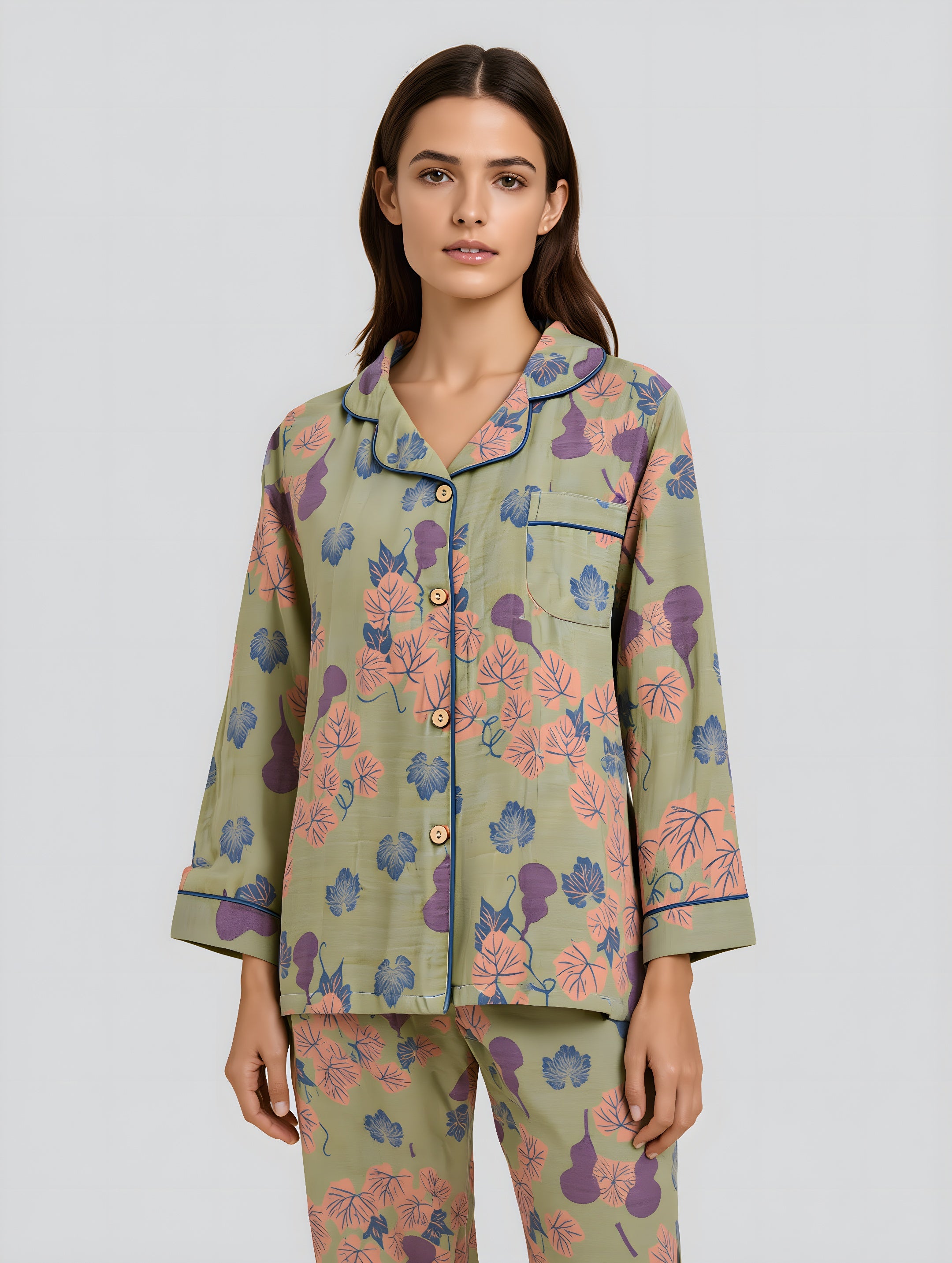 Woman wearing a floral pajama set on a light gray background